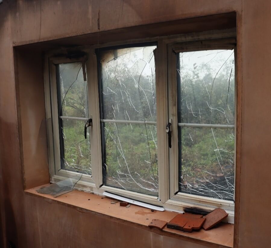 Heat-damaged window from a previous Hawkins investigation