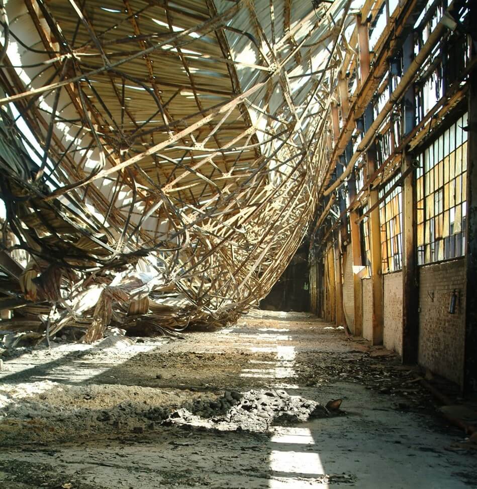 Image of a structural collapse of a steel framed roof caused by fire