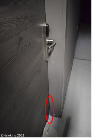 Picture shows laminate warping at the base of a door which has then damaged the door