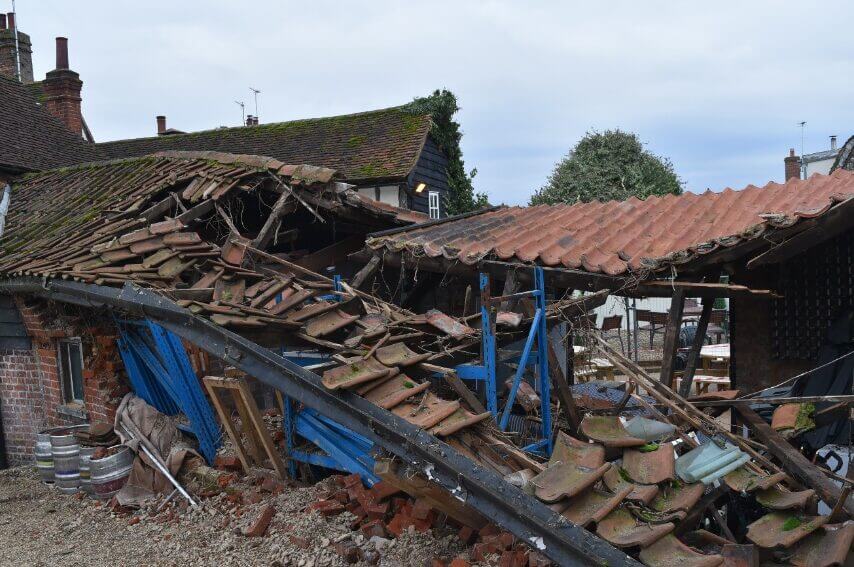 image showing a building turned into ruins and collapsed by strong winds