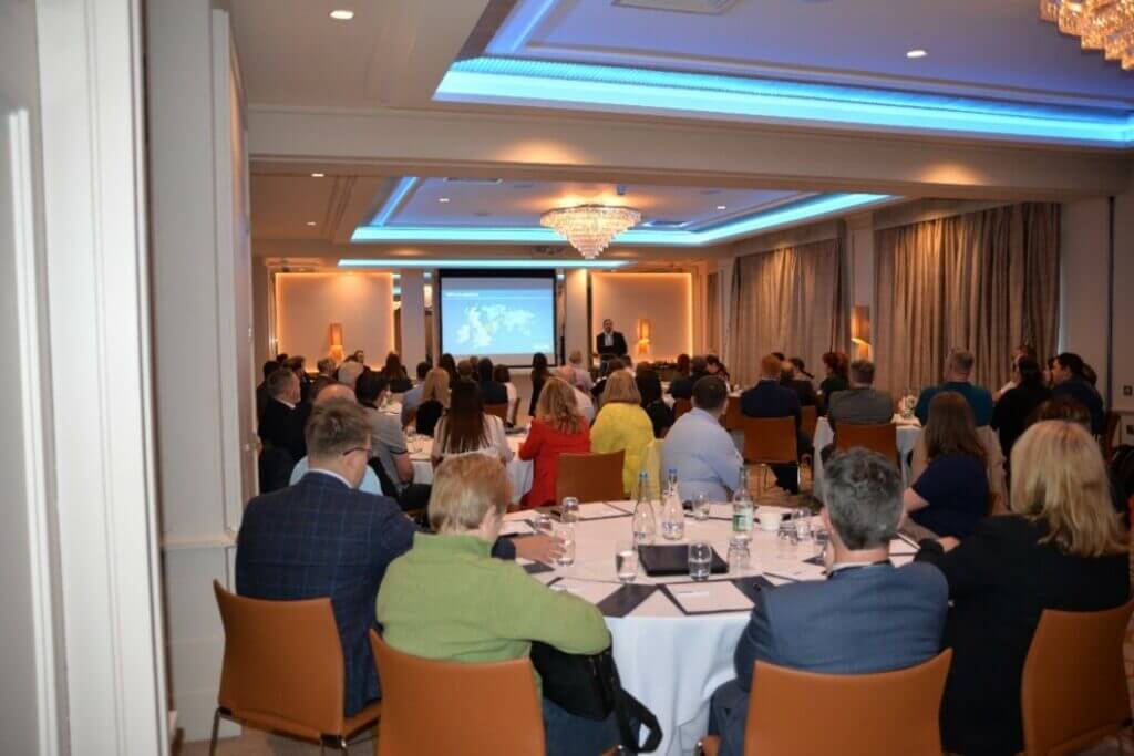 Photo of John Holland welcoming guests to our Belfast reception