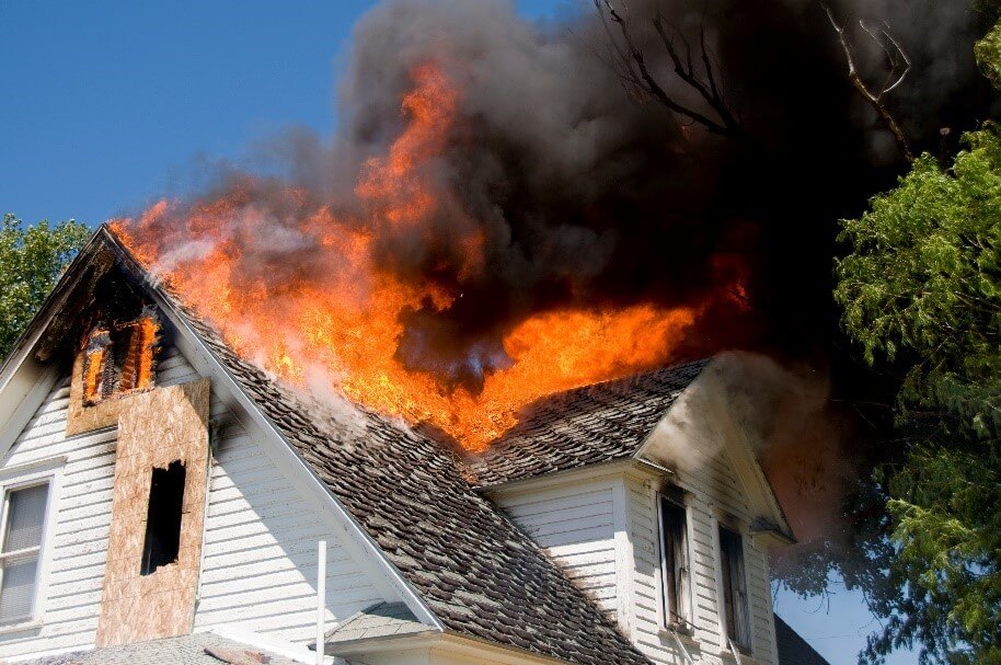 Residential property on fire with flames across the rooftop