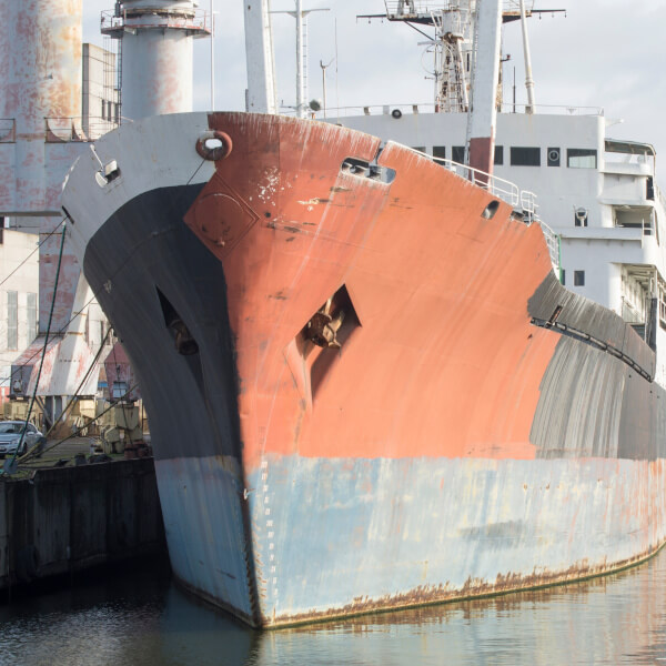 Old ship near the pier in the port.