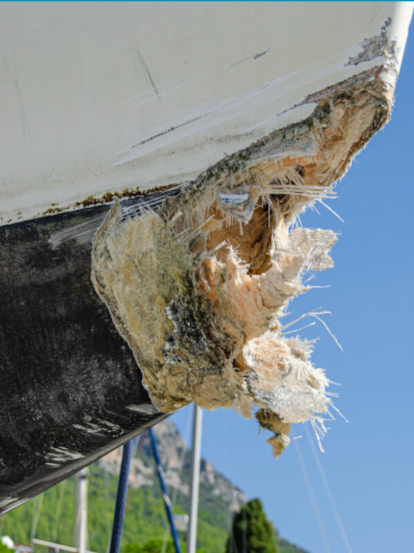 The collision-damaged bow of the fiberglass yacht.